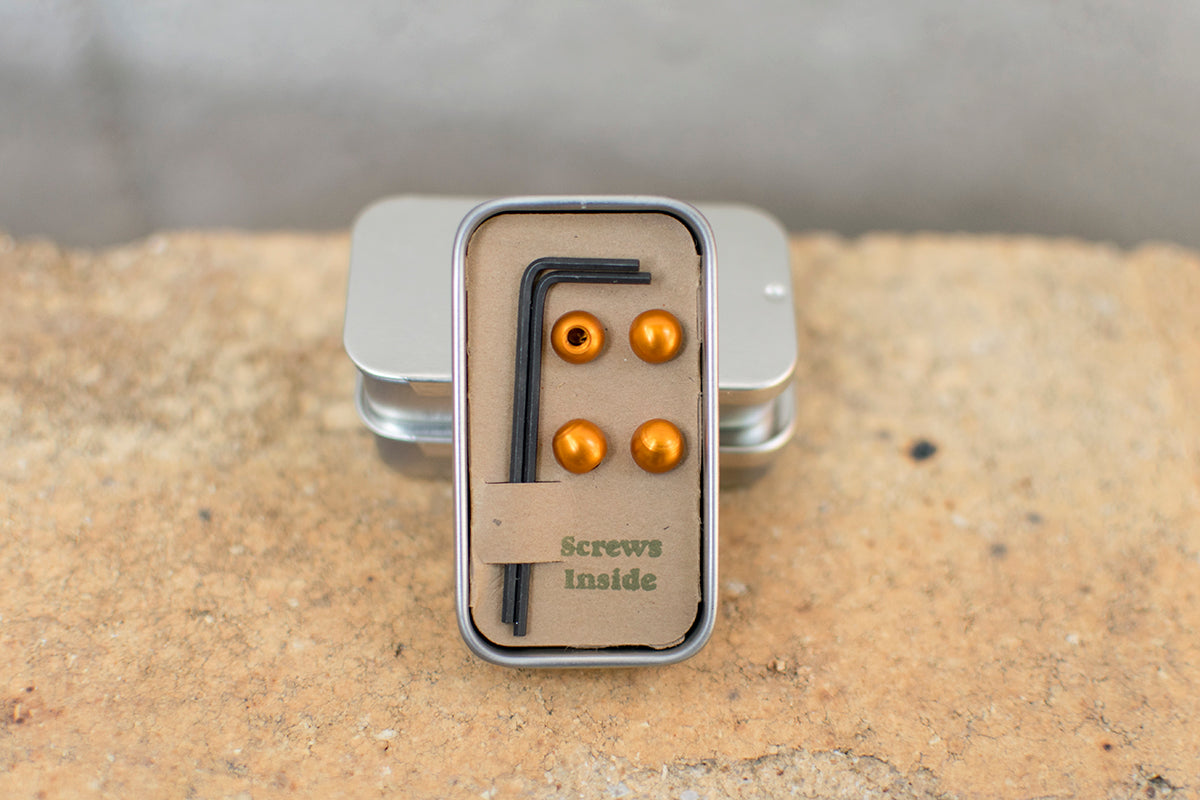 Small tin with four orange cable cherries and two Bondhus hex keys.