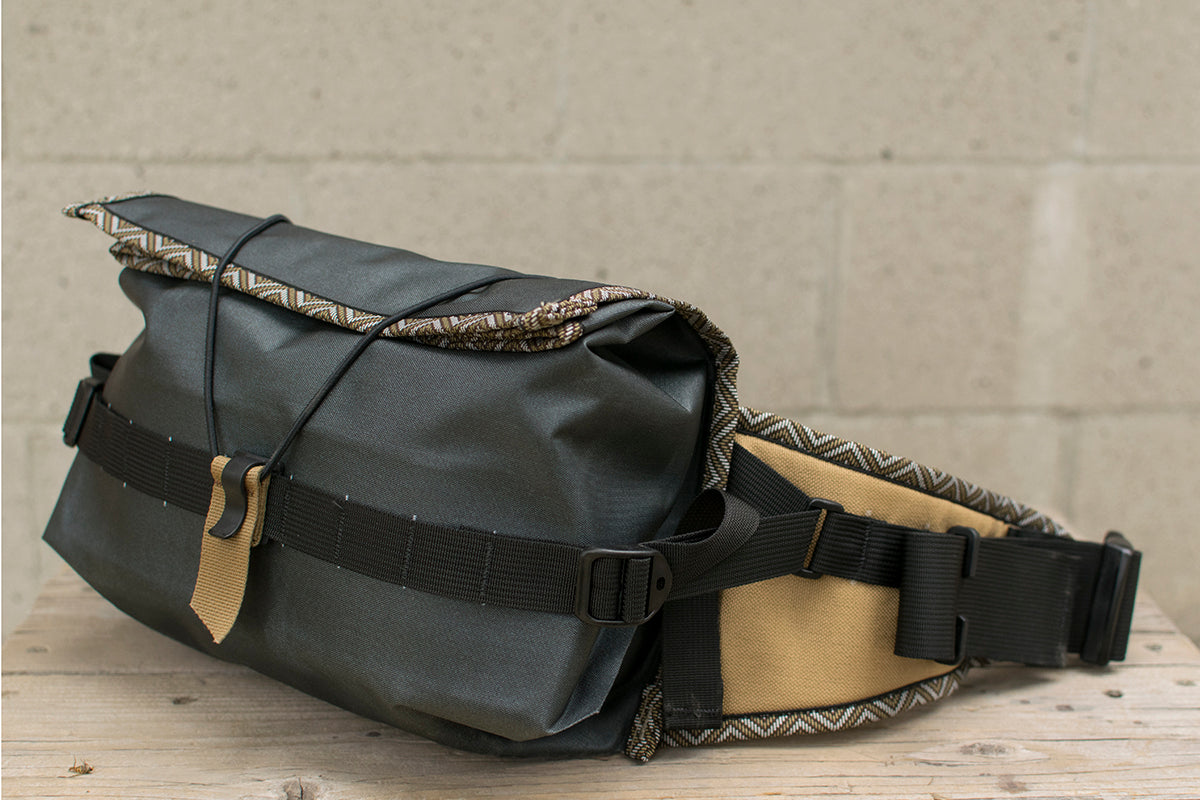 Side view of grey Big Dumpling hip pack with Great Horned Owl trim tape.