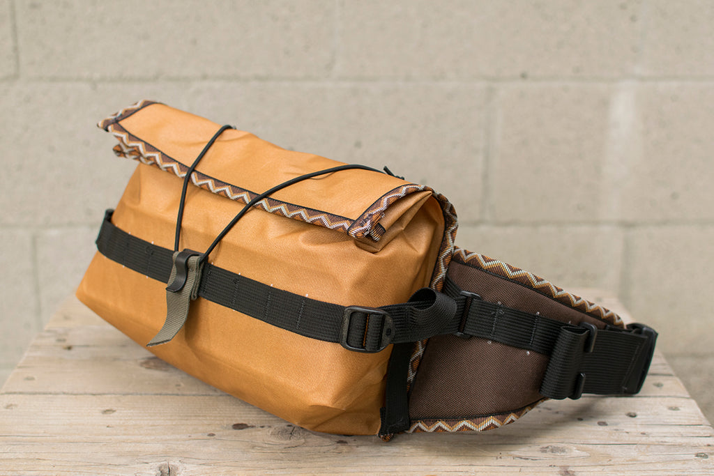 Side view of orange Big Dumpling hip pack with Western Rattler trim tape.