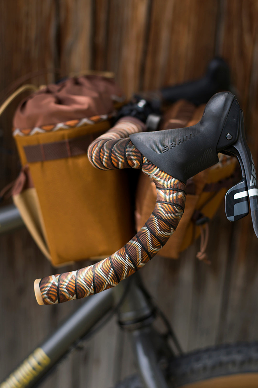 Close-up of a bicycle handlebar with Camp and Go Slow Western Rattler bartape