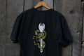 Black t-shirt with a Eastern Rattler snake and spork design on a wooden background.
