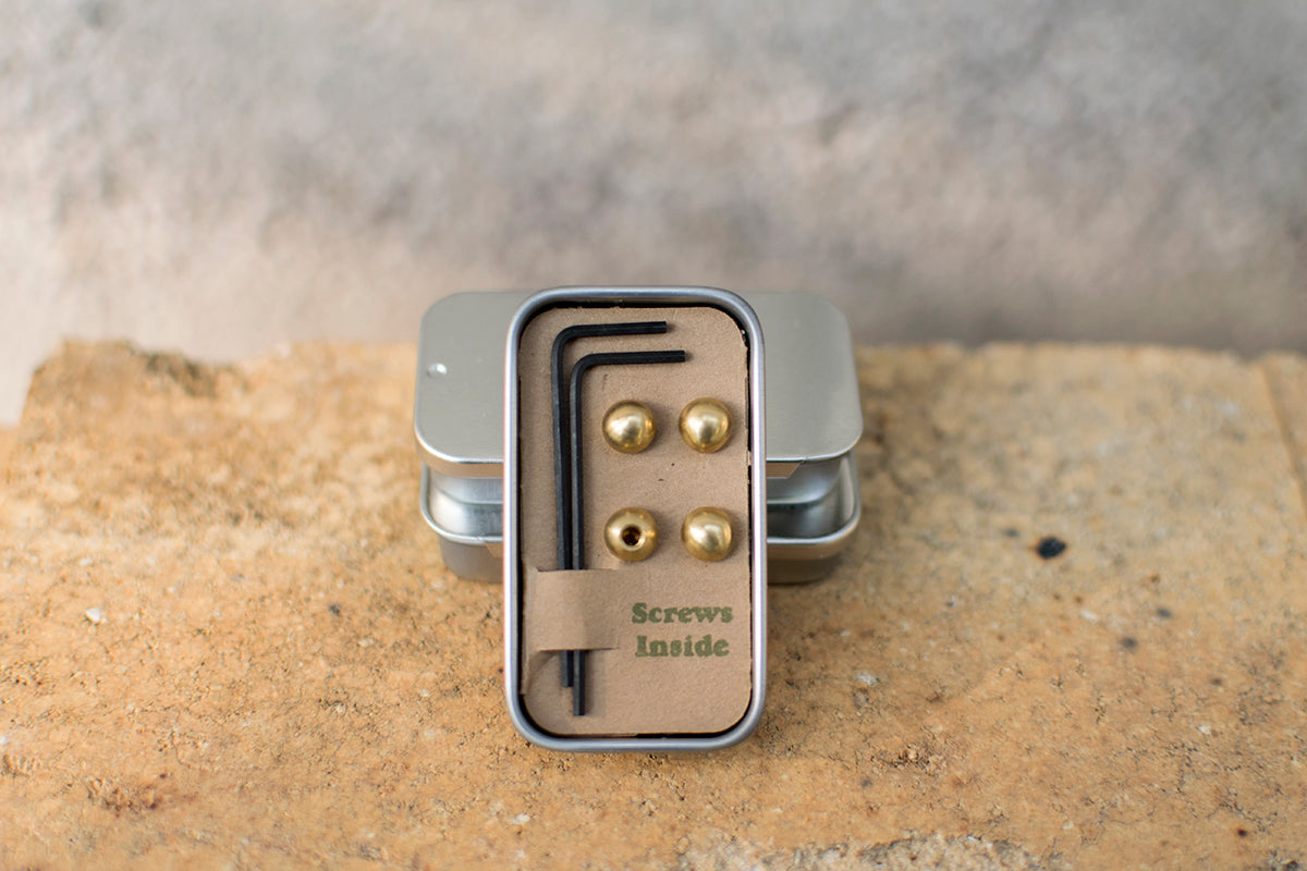 Small tin with four brass cable cherries and two Bondhus hex keys.