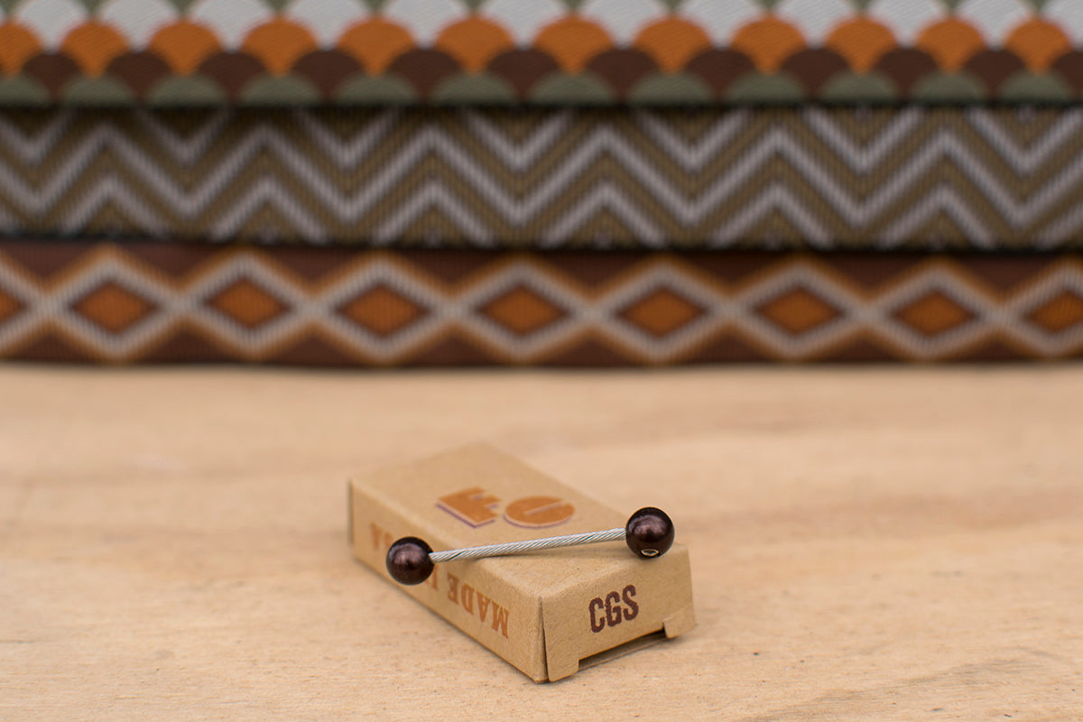 Western Brown cable cherries on a wooden surface with patterned Camp And Go Slow bar tape in the background.