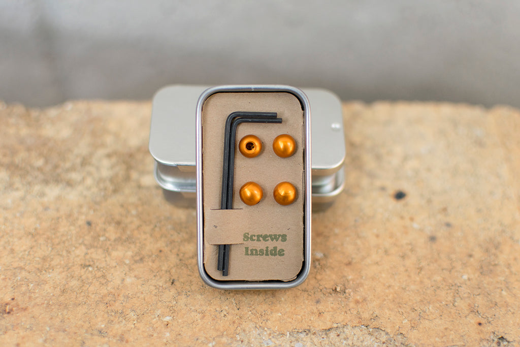 Small tin with four orange cable cherries and two Bondhus hex keys.