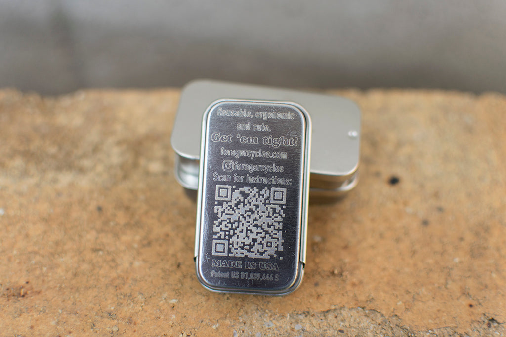 Forager tin with a QR code on a textured surface