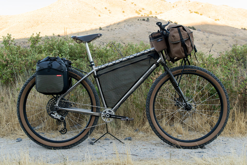 Full Triangle frame bag in olive X-Pac on a loaded titanium touring rig
