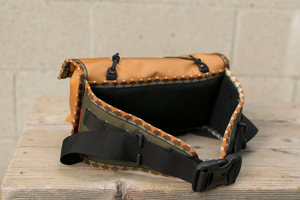 Back view of orange Little Dumpling hip pack with Brown Trout trim tape.