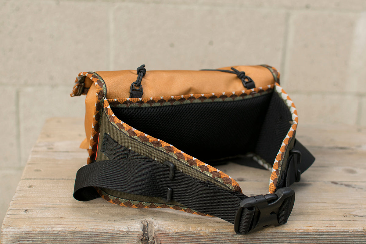 Back view of orange Little Dumpling hip pack with Brown Trout trim tape.