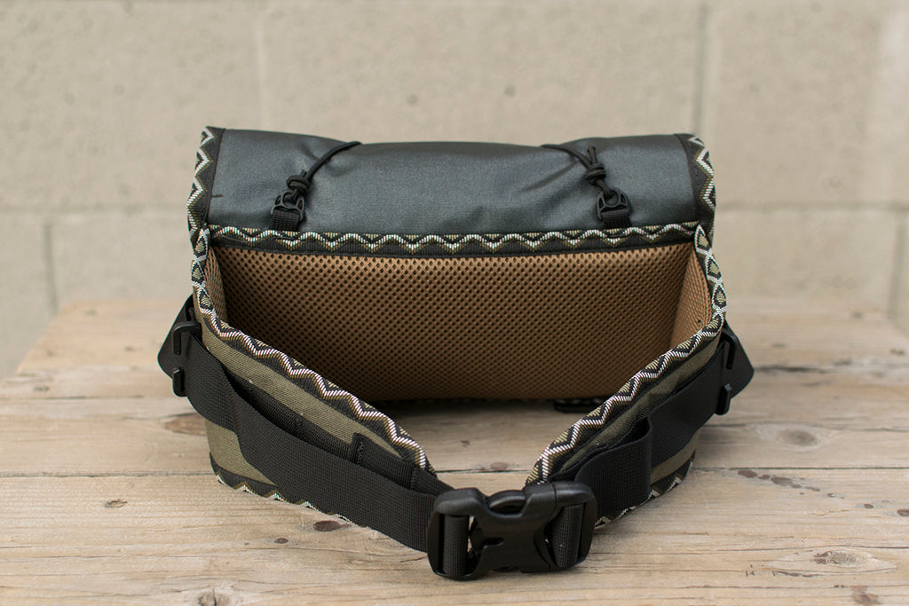 Back view of grey Little Dumpling hip pack with Eastern Rattler trim tape.