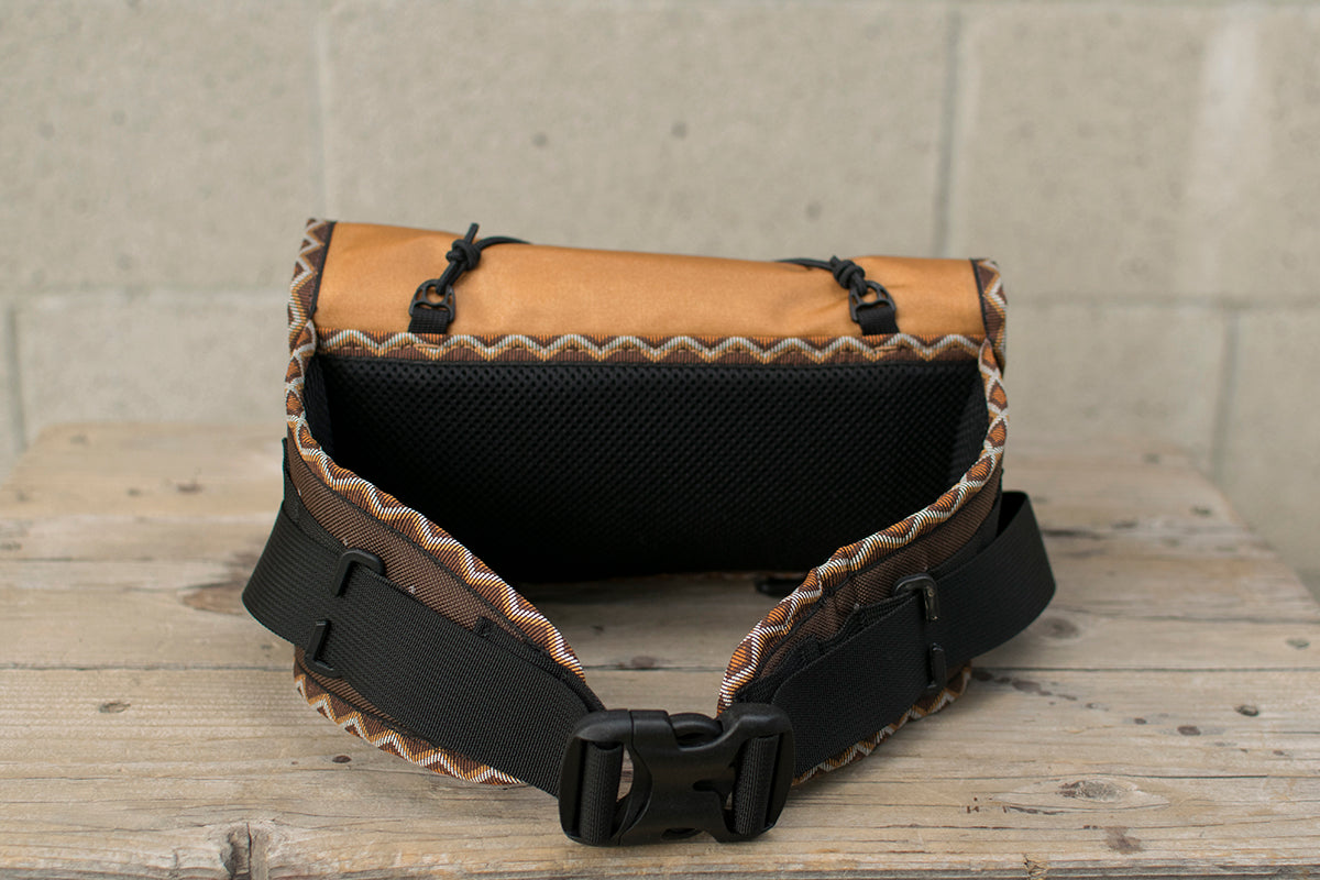 Back view of orange Little Dumpling hip pack with Western Rattler trim tape.